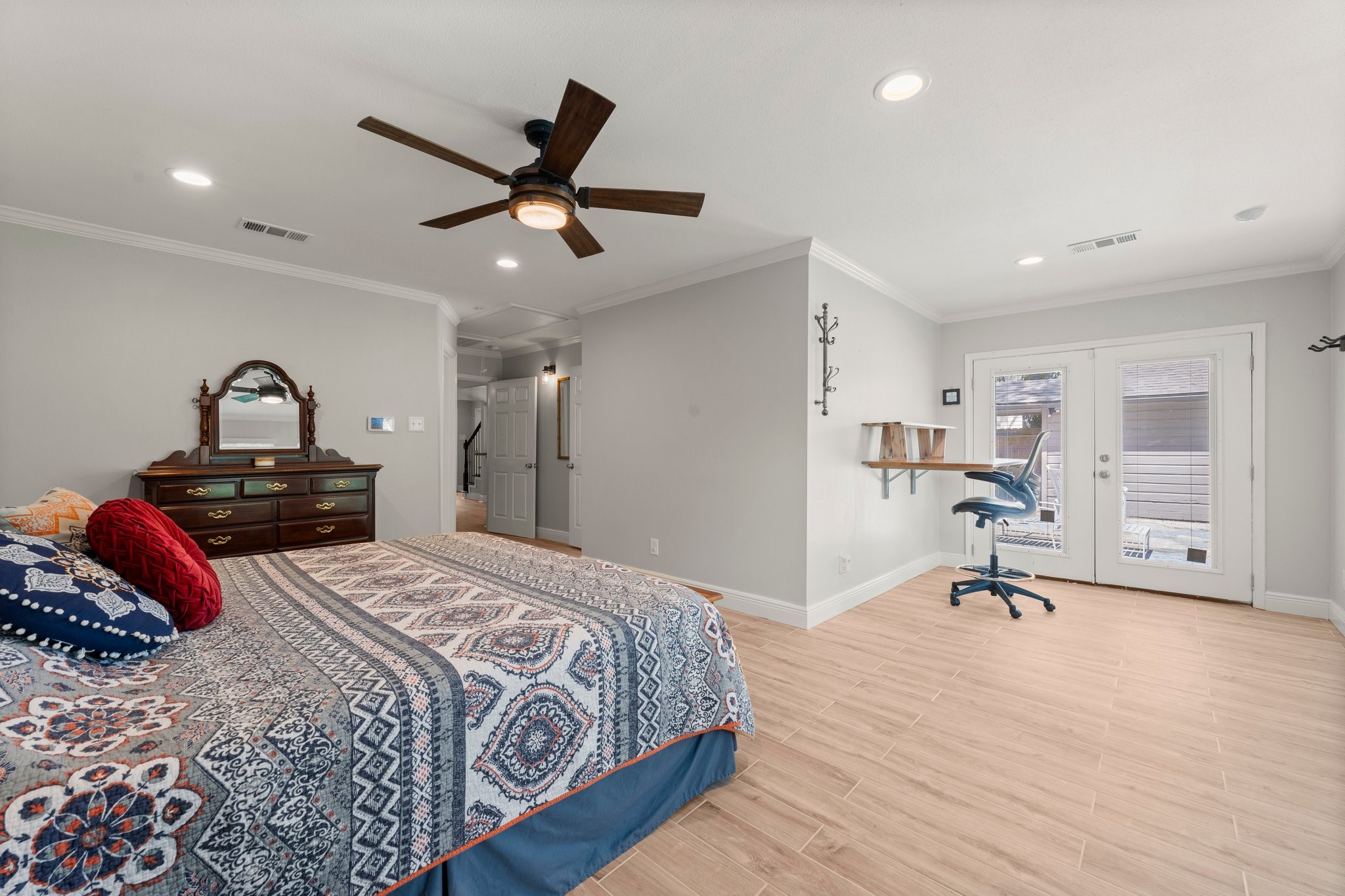 6030 Craigway Road Spring, TX 77389 - Photo 21 of 45 Spacious bedroom features ample natural light from large French doors, and a cozy nook for a desk or seating area.