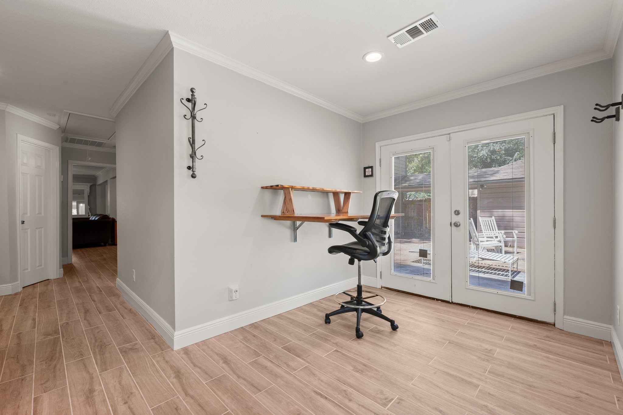 6030 Craigway Road Spring, TX 77389 - Photo 22 of 45 Bright, spacious bedroom featuring a wall-mounted desk. Double glass doors open to a patio area, offering natural light and outdoor views.
