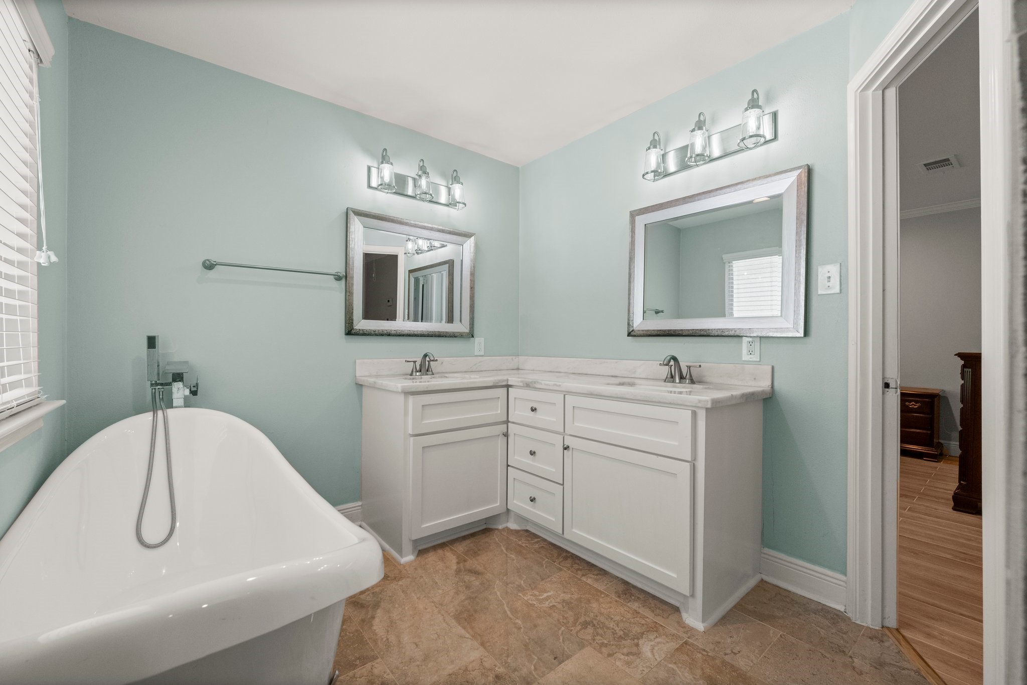 6030 Craigway Road Spring, TX 77389 - Photo 24 of 45 Bathroom featuring a modern design with a freestanding clawfoot bathtub, and a dual-sink vanity.