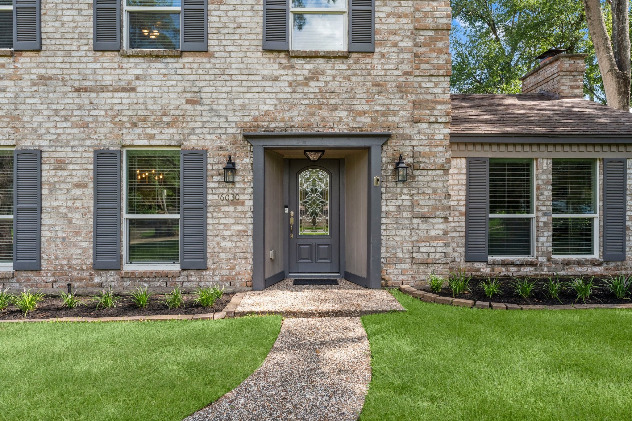 6030 Craigway Road Spring, TX 77389 - Photo 4 of 45 Charming brick home with a warm, inviting entrance and beautifully maintained landscaping that adds to its curb appeal.
