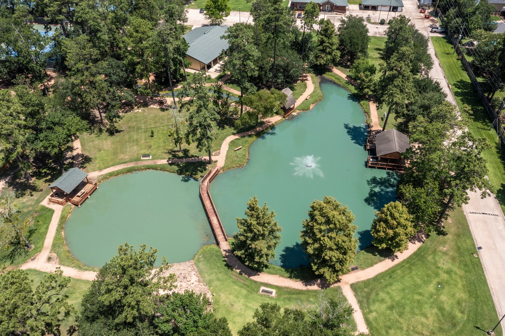 6030 Craigway Road Spring, TX 77389 - Photo 42 of 45 Aerial photo showcases the beautifully landscaped lake, complete with a central fountain and two gazebo-style structures.