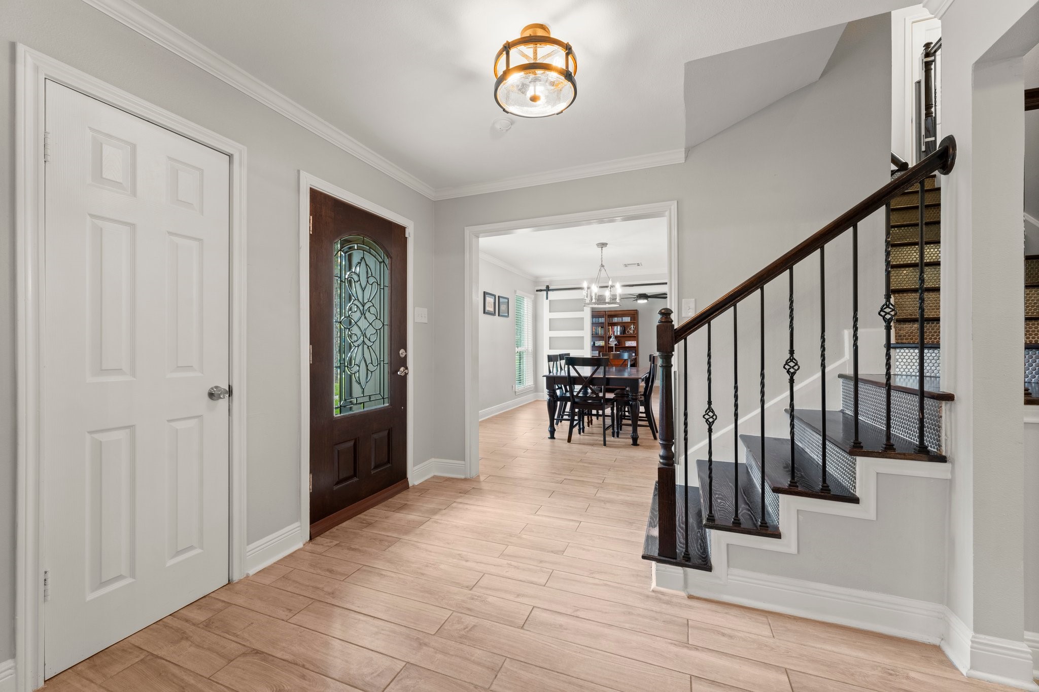 6030 Craigway Road Spring, TX 77389 - Photo 6 of 45 This welcoming entryway showcases a stylish wooden door with decorative glass and a staircase accented by an elegant railing leading to the upper level.