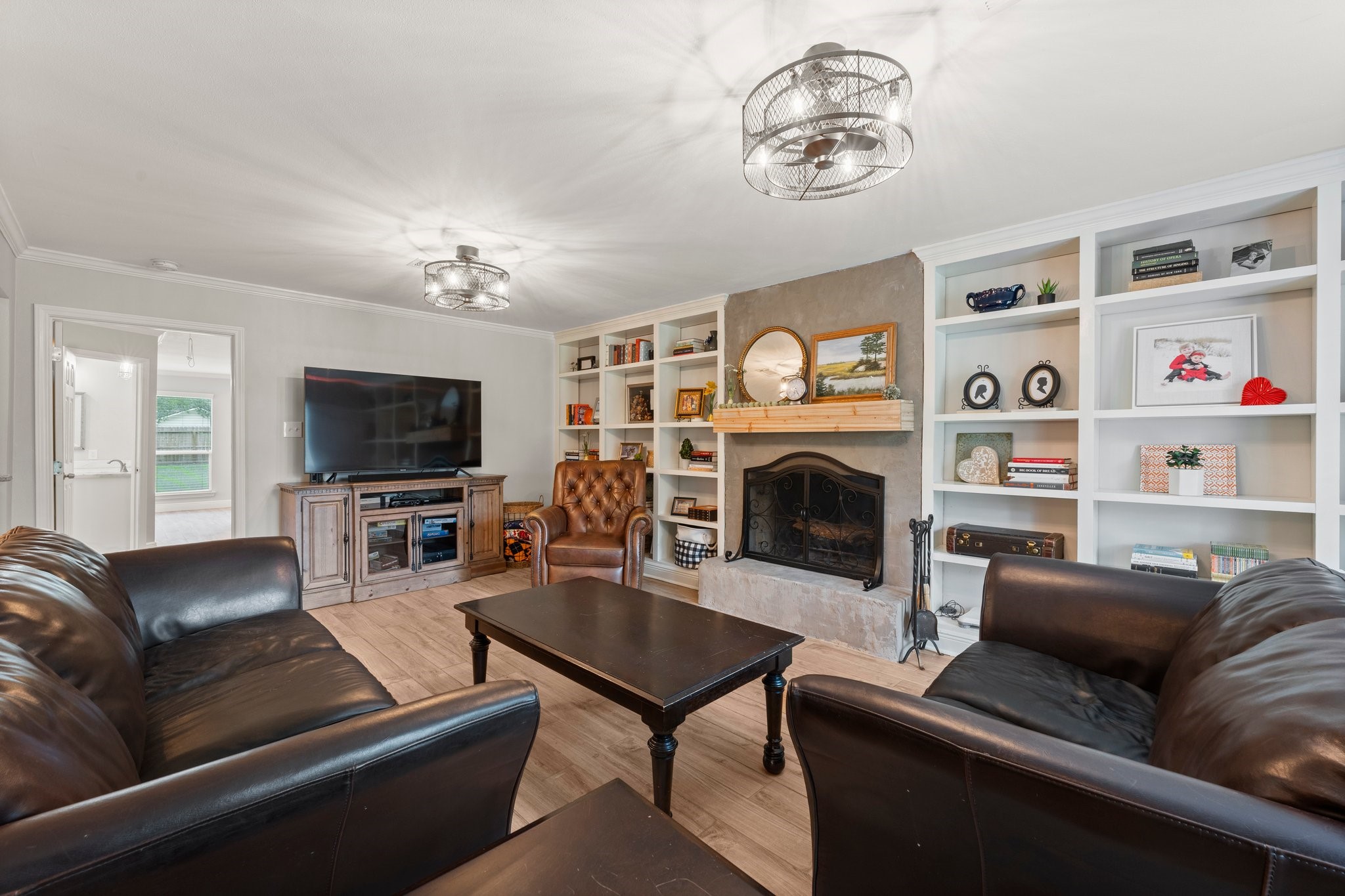 6030 Craigway Road Spring, TX 77389 - Photo 9 of 45 Spacious living room featuring a cozy fireplace and built-in shelves, creating a warm and inviting atmosphere.