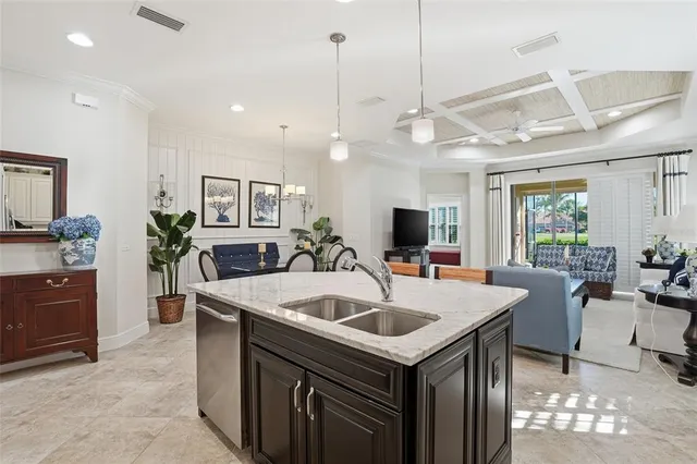 a kitchen that has a sink a table and chairs in it