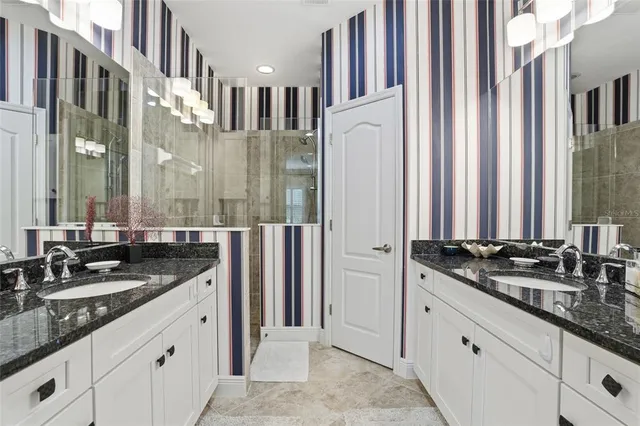 a bathroom with double sink and a mirror