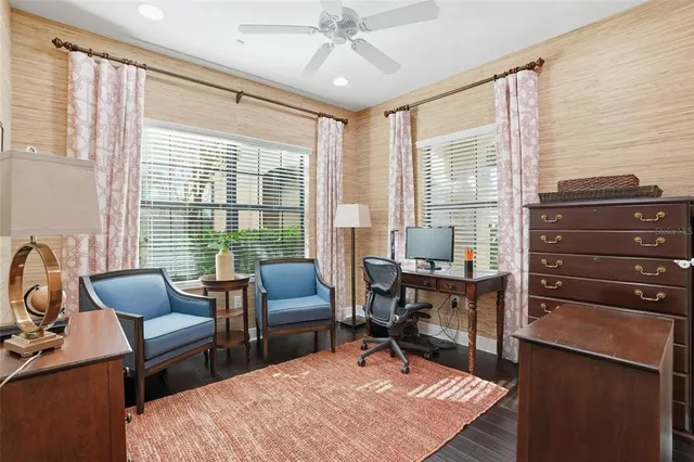 a view of a workspace with furniture and a window