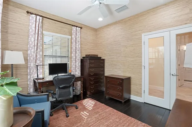 a view of a workspace with furniture and a window