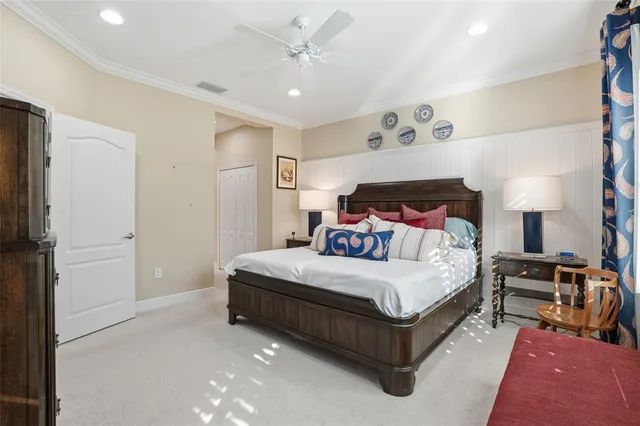 a bedroom with a bed lamp closet and a large window