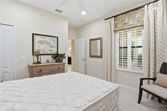 a bedroom with a large bed and a window