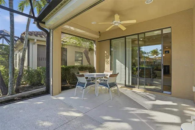 a patio with yard glass top table and chairs