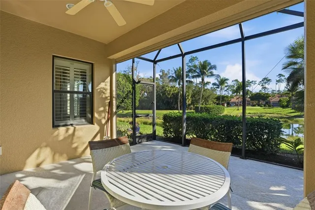 a view of a patio with a table chairs and a backyard