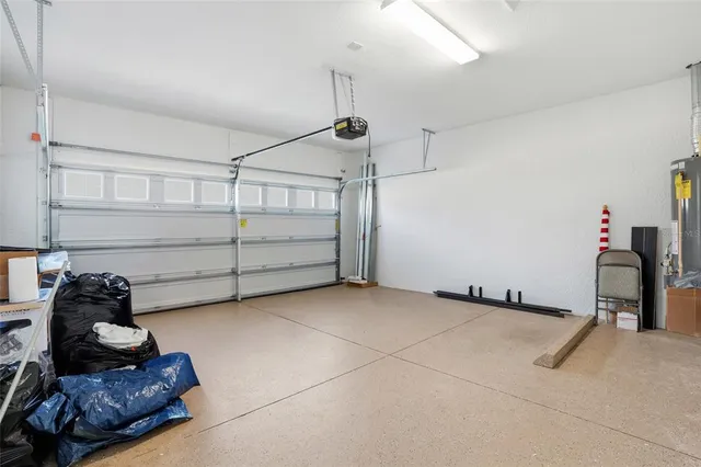 a room with gym equipment and wooden floor