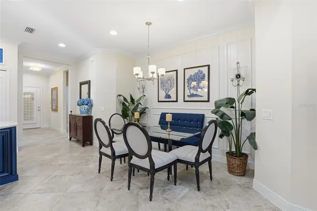 a dining room with furniture and potted plant