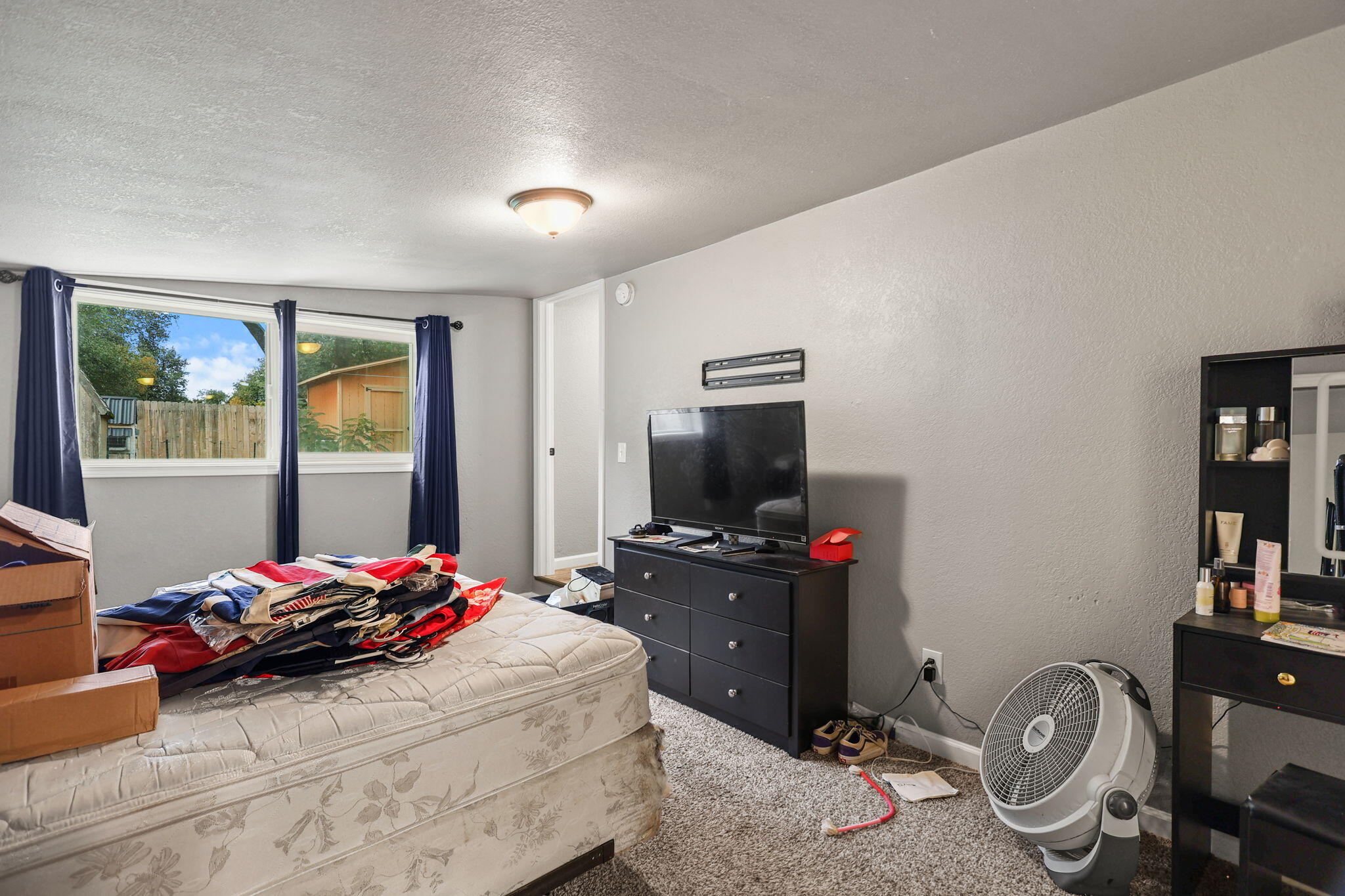 7696 Happy Valley Road Anderson, CA 96007 - Photo 11 of 24 a bedroom with a bed and a flat screen tv