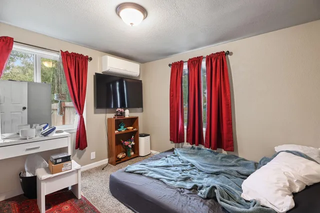 a bedroom with a bed and a mirror