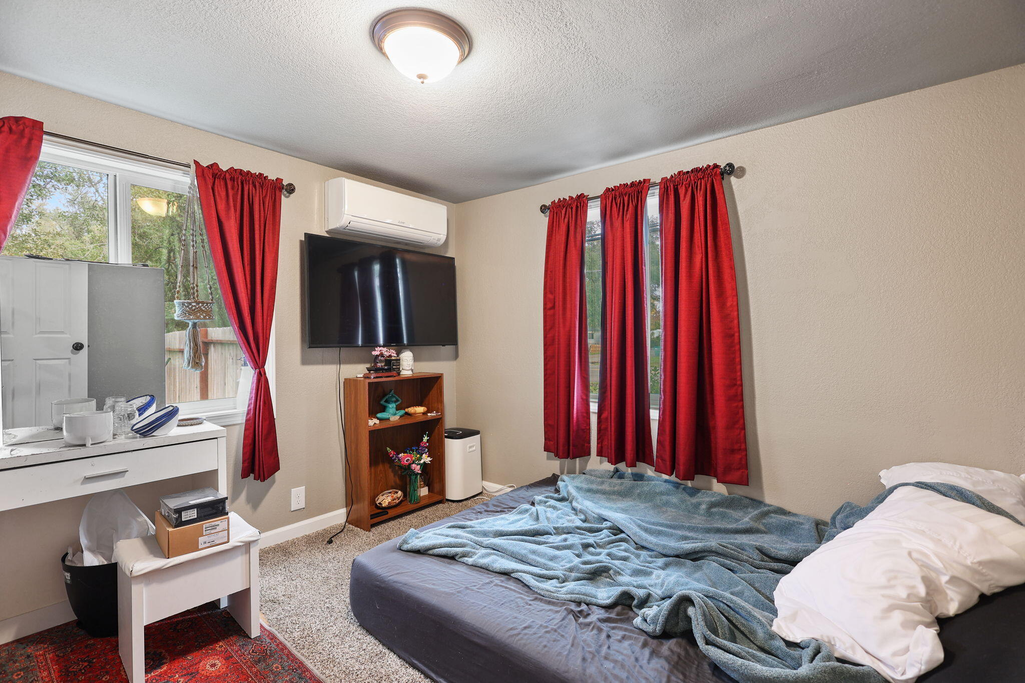 7696 Happy Valley Road Anderson, CA 96007 - Photo 13 of 24 a bedroom with a bed and a mirror