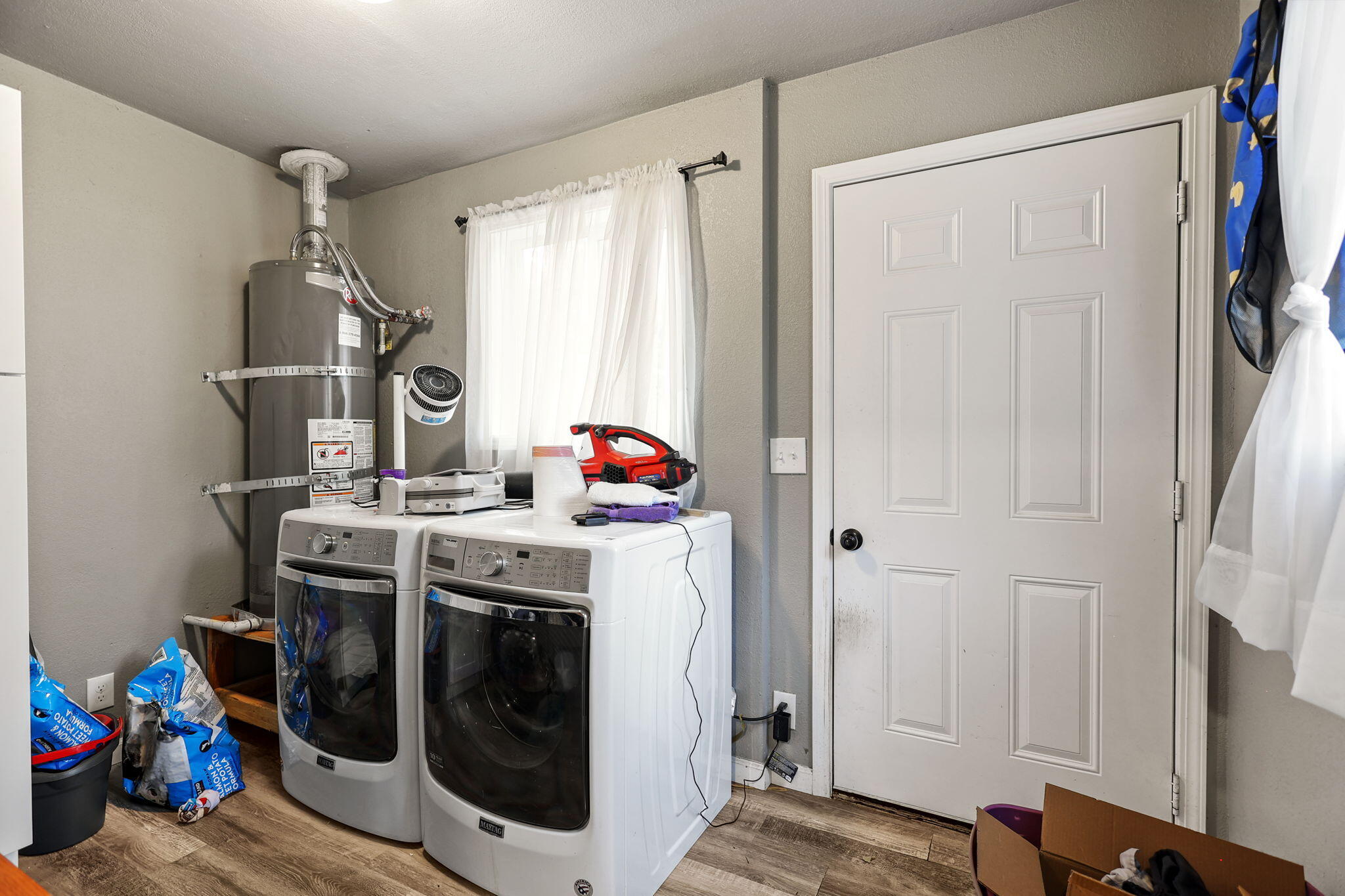 7696 Happy Valley Road Anderson, CA 96007 - Photo 15 of 24 a view of a storage and utility room with washer and dryer