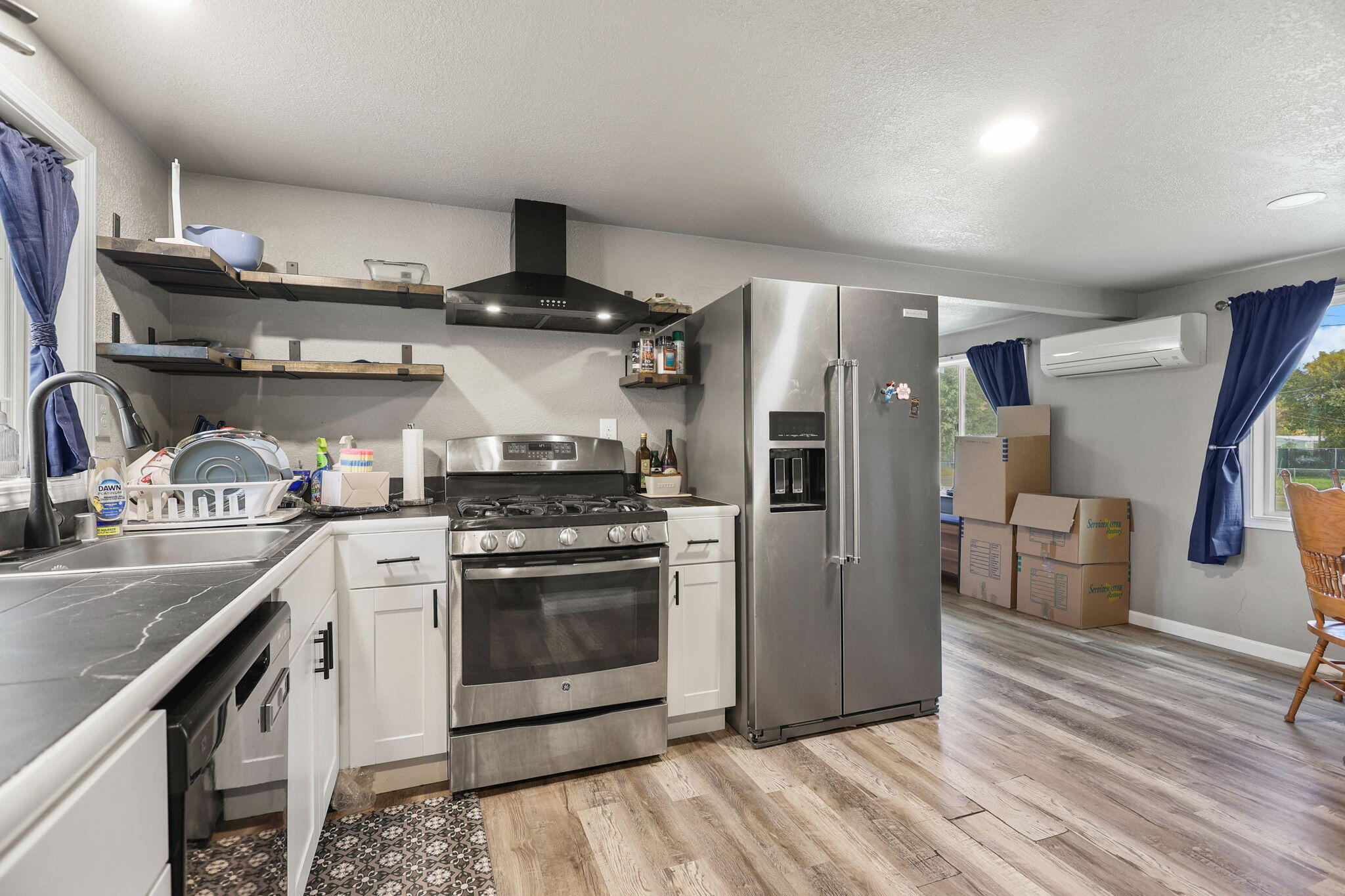 7696 Happy Valley Road Anderson, CA 96007 - Photo 4 of 24 a kitchen with stainless steel appliances granite countertop a stove and a refrigerator