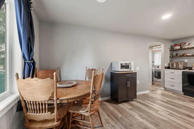a view of a dining room with furniture and wooden floor