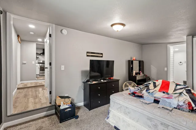 a bedroom with a bed and a computer on the desk