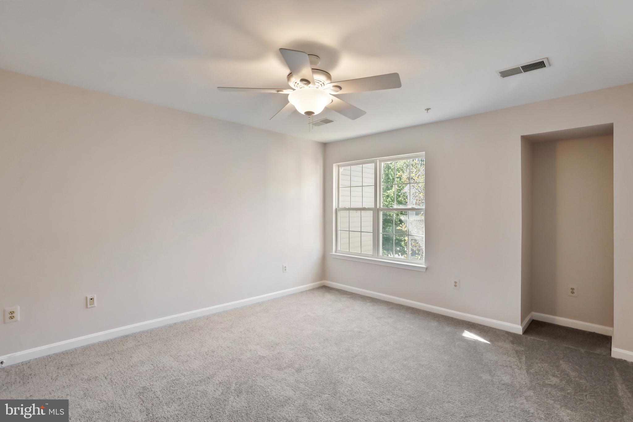 1802 Spanish Oak Lane Bowie, MD 20721 - Photo 13 of 53 a view of a livingroom with a ceiling fan and window