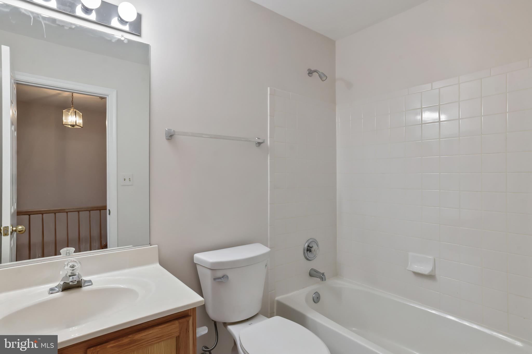1802 Spanish Oak Lane Bowie, MD 20721 - Photo 19 of 53 a bathroom with a sink toilet a vanity and shower