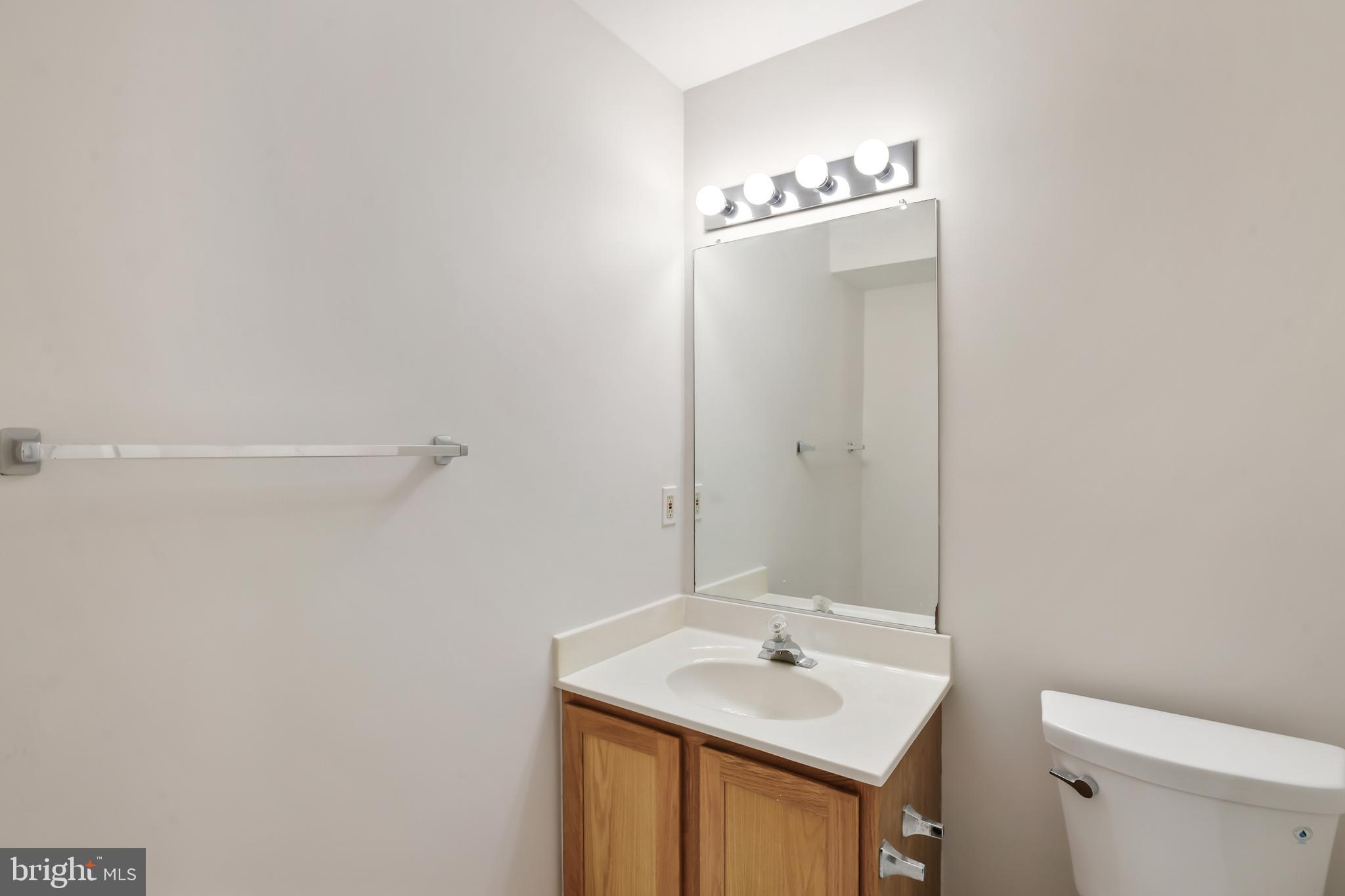 1802 Spanish Oak Lane Bowie, MD 20721 - Photo 27 of 53 a bathroom with a sink a toilet and mirror