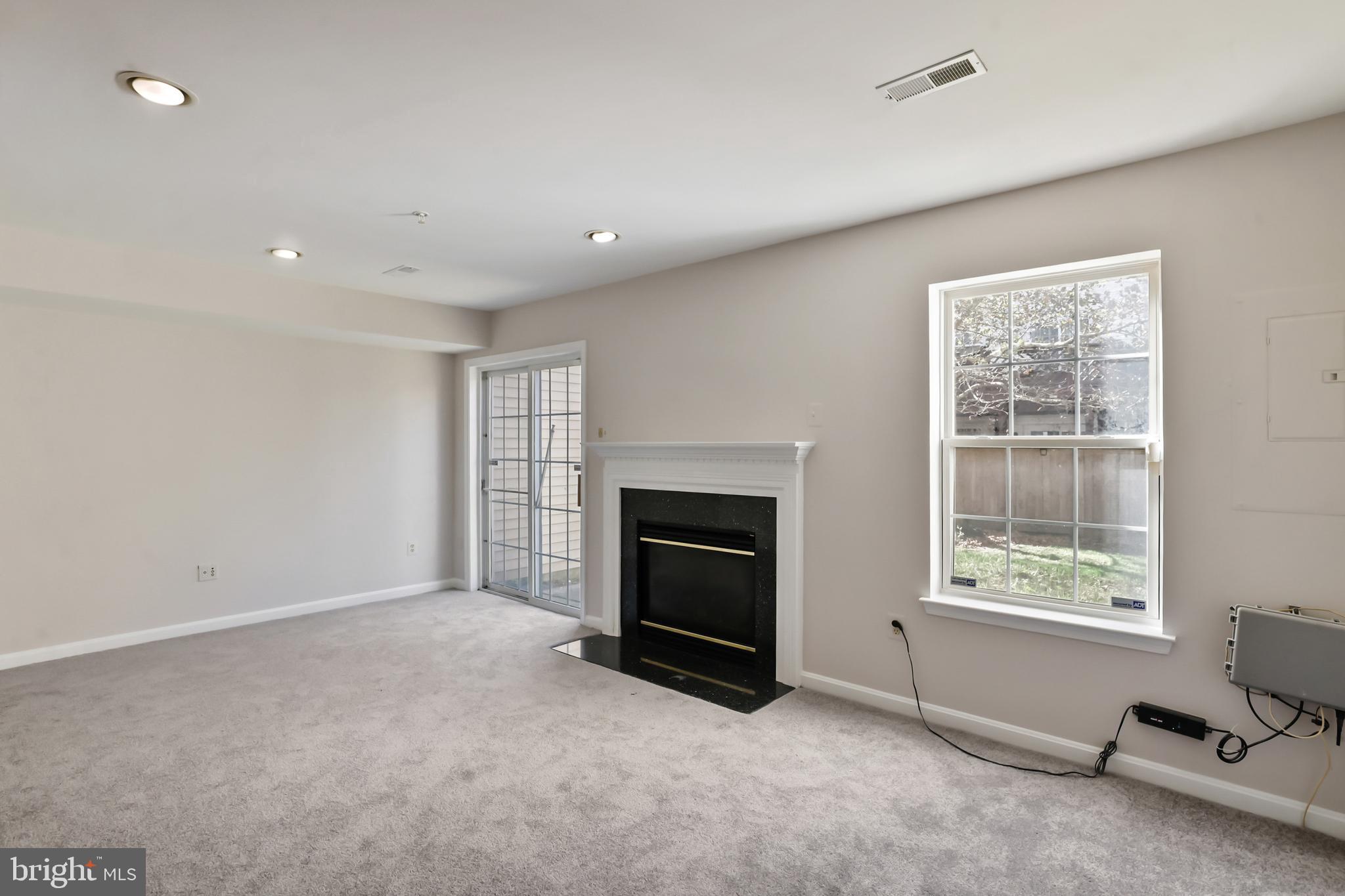 1802 Spanish Oak Lane Bowie, MD 20721 - Photo 28 of 53 a big room with windows and a fireplace