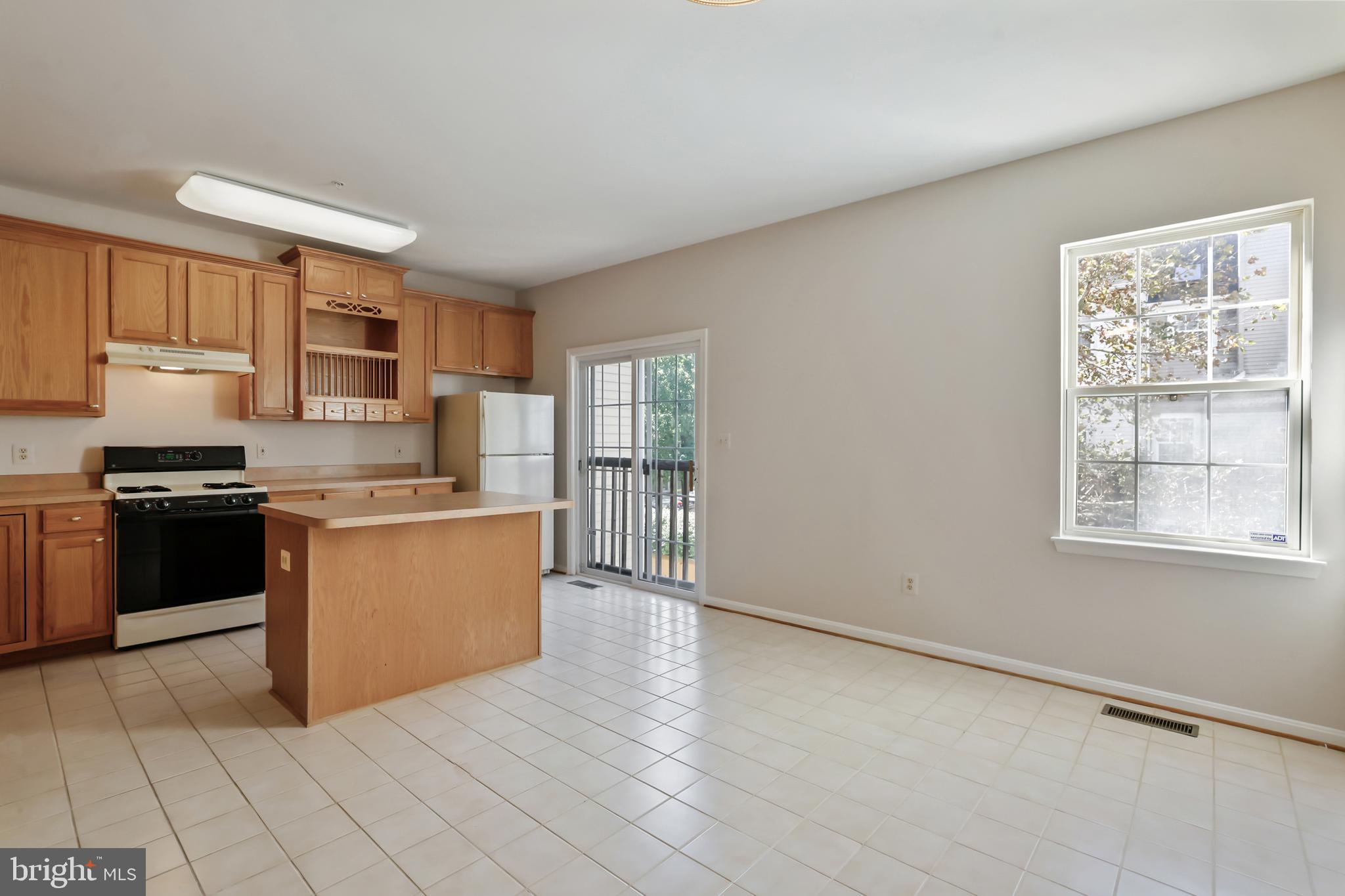 1802 Spanish Oak Lane Bowie, MD 20721 - Photo 9 of 53 a kitchen with granite countertop a stove a sink and a refrigerator