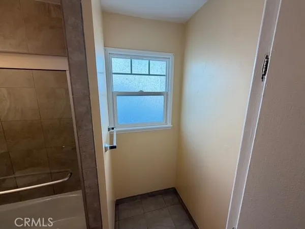 a bathroom with a glass door shower