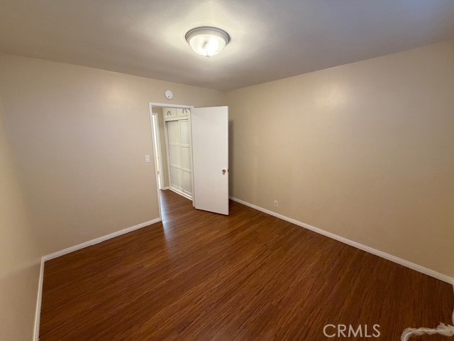 25 Genoa Street, Unit D Arcadia, CA 91006 - Photo 16 of 22 an empty room with wooden floor and windows