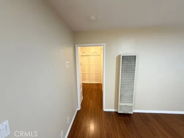 a view of wooden floor and windows in a room
