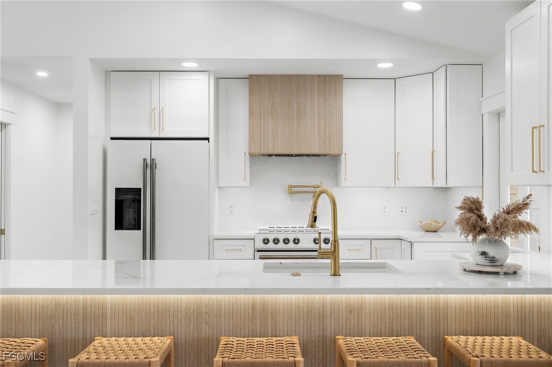 13270 Electron Drive Fort Myers, FL 33908 - Photo 11 of 47 a kitchen with stainless steel appliances granite countertop a sink a refrigerator and a granite counter tops