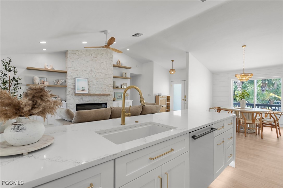 13270 Electron Drive Fort Myers, FL 33908 - Photo 17 of 47 a kitchen with kitchen island granite countertop a sink and white cabinets