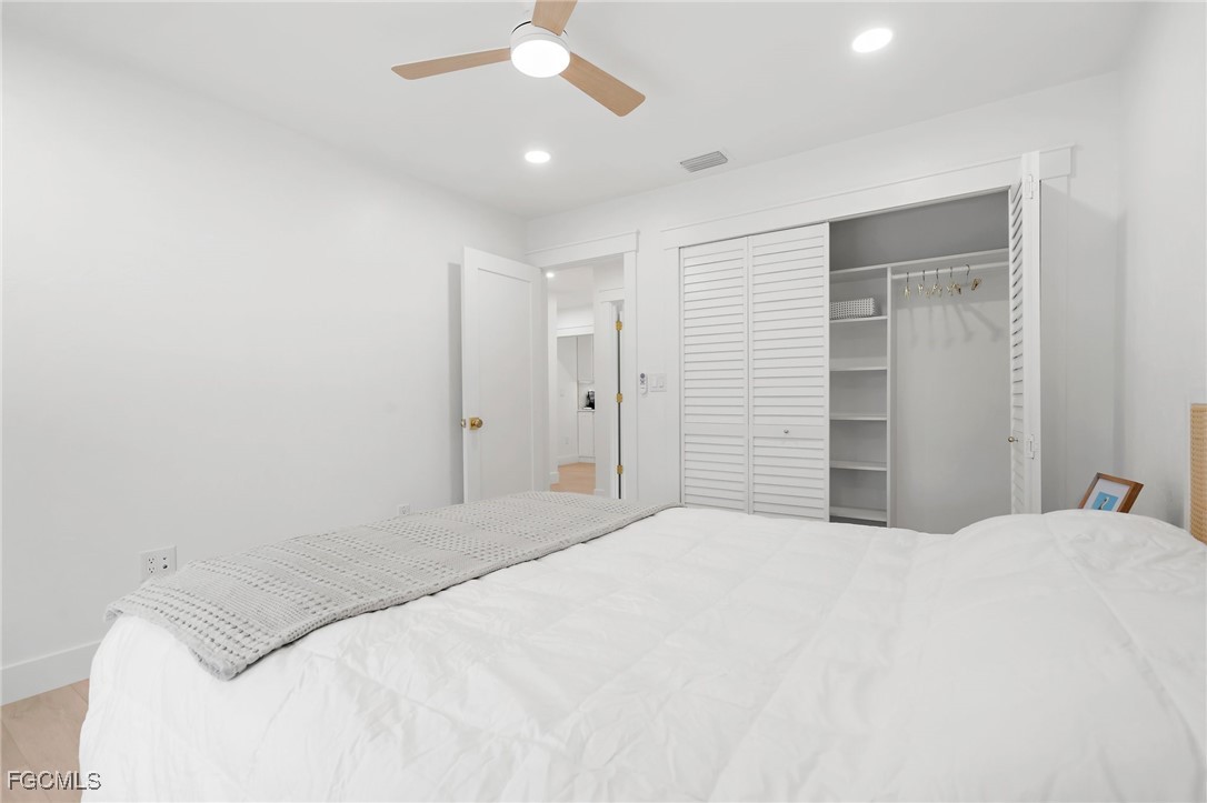 13270 Electron Drive Fort Myers, FL 33908 - Photo 22 of 47 a bedroom with a bed and a ceiling fan