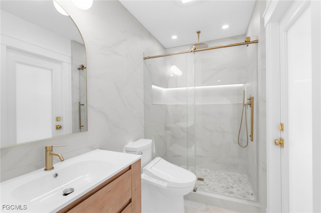 13270 Electron Drive Fort Myers, FL 33908 - Photo 24 of 47 a bathroom with a sink a toilet and shower