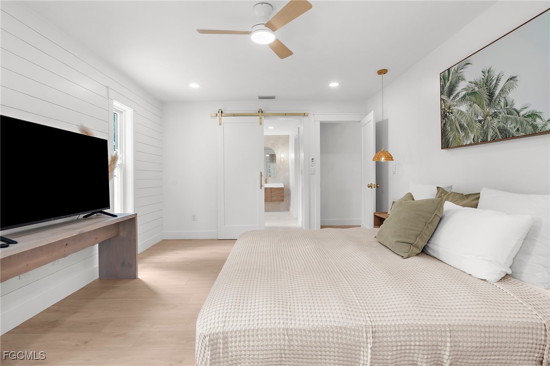 13270 Electron Drive Fort Myers, FL 33908 - Photo 27 of 47 a bedroom with a bed and a flat screen tv