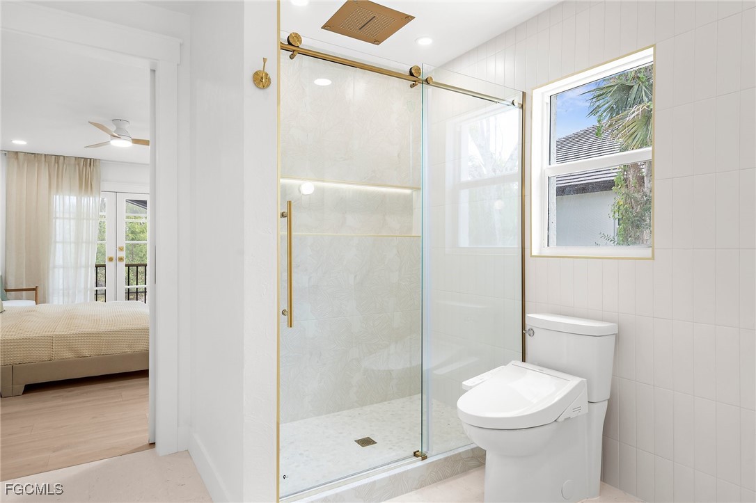 13270 Electron Drive Fort Myers, FL 33908 - Photo 29 of 47 a bathroom with a shower a toilet and a window