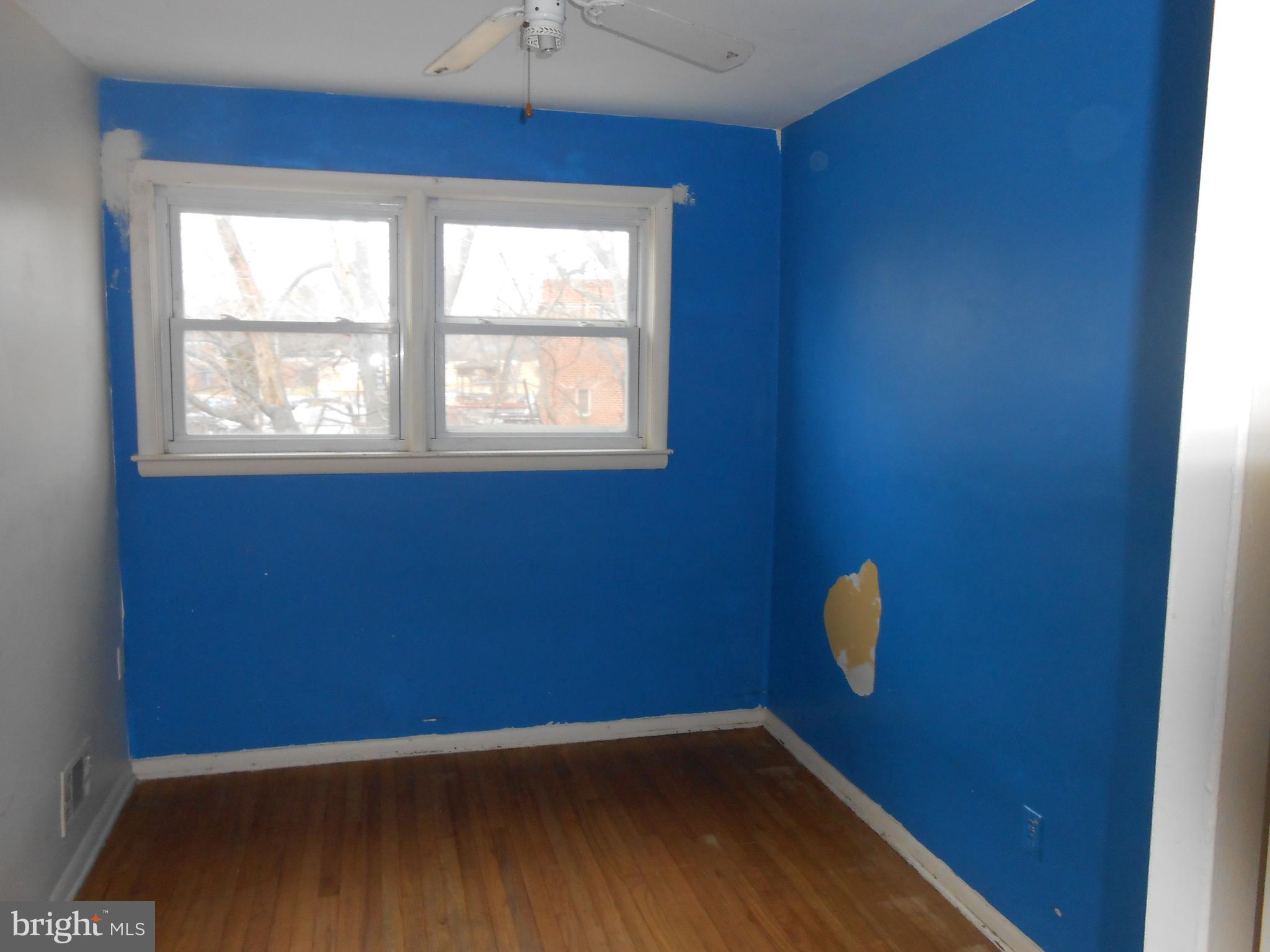 4211 Crest Heights Road Baltimore, MD 21215 - Photo 17 of 21 a view of a room with wooden floor and windows
