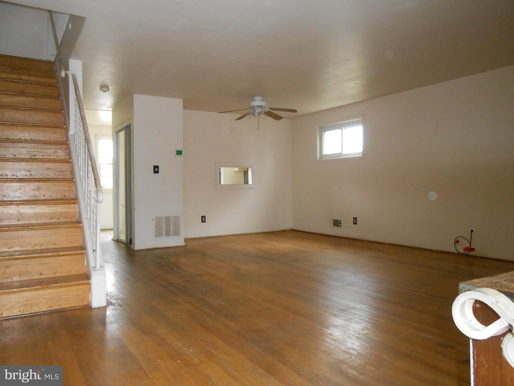 4211 Crest Heights Road Baltimore, MD 21215 - Photo 3 of 21 a view of a livingroom with wooden floor and window