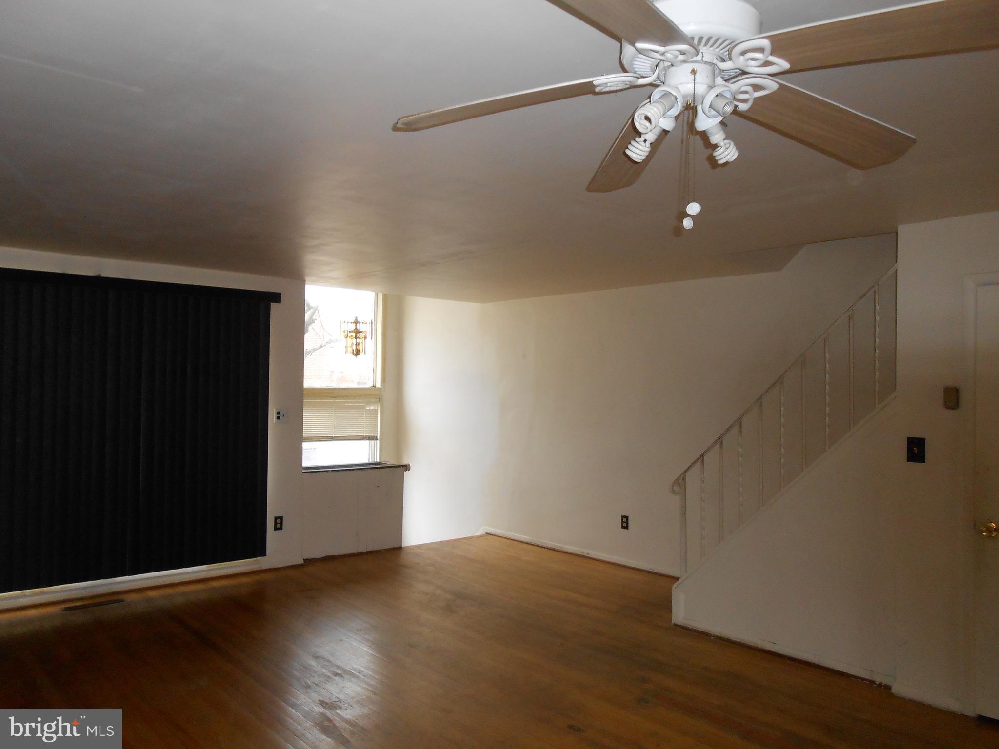 4211 Crest Heights Road Baltimore, MD 21215 - Photo 4 of 21 wooden floor in an empty room with a window