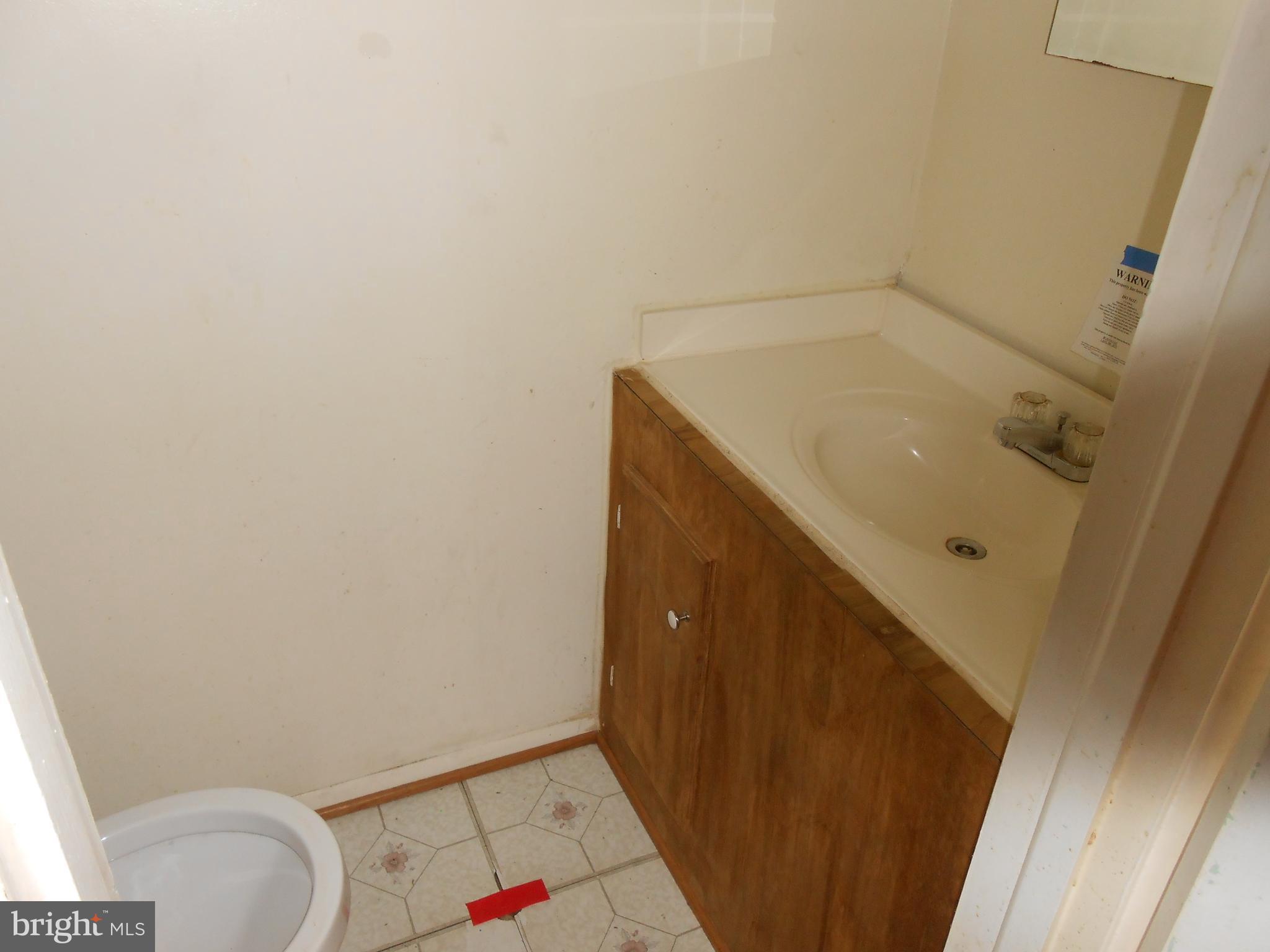 4211 Crest Heights Road Baltimore, MD 21215 - Photo 8 of 21 a bathroom with a sink and vanity