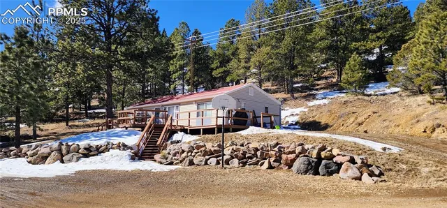 a view of a house with a yard covered in snow