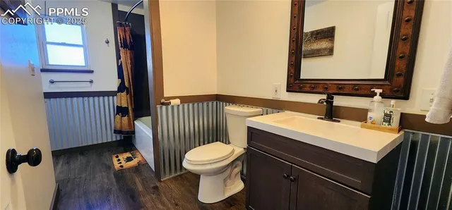 a bathroom with a sink toilet and mirror