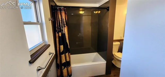 a bathroom with a tub and shower