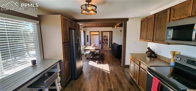a kitchen with a stove a microwave and wooden floor