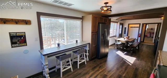 a dining room with furniture and wooden floor