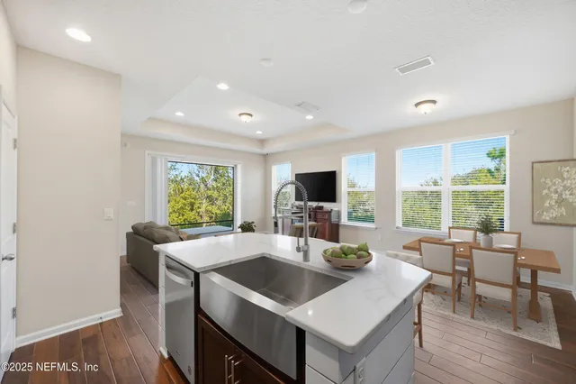 a view of a livingroom with furniture and kitchen view