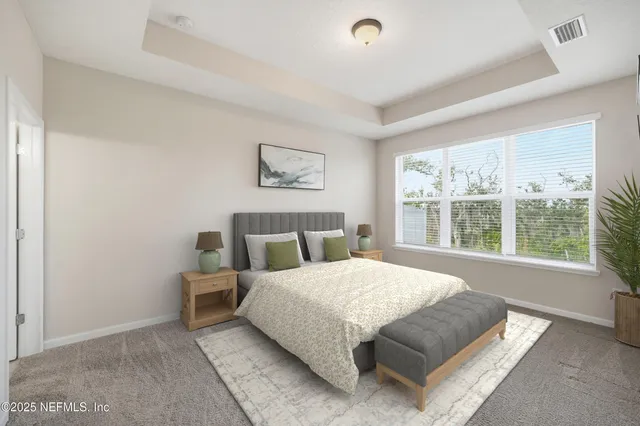 a bedroom with a bed lamp and window