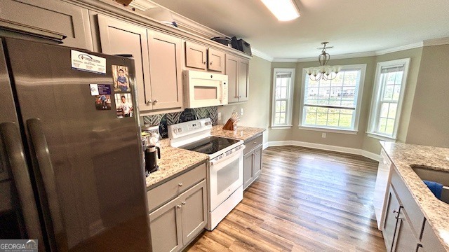 4 Savannah Place Rome, GA 30165 - Photo 10 of 19 a kitchen with stainless steel appliances granite countertop a refrigerator a sink dishwasher a stove and white countertops with wooden floor